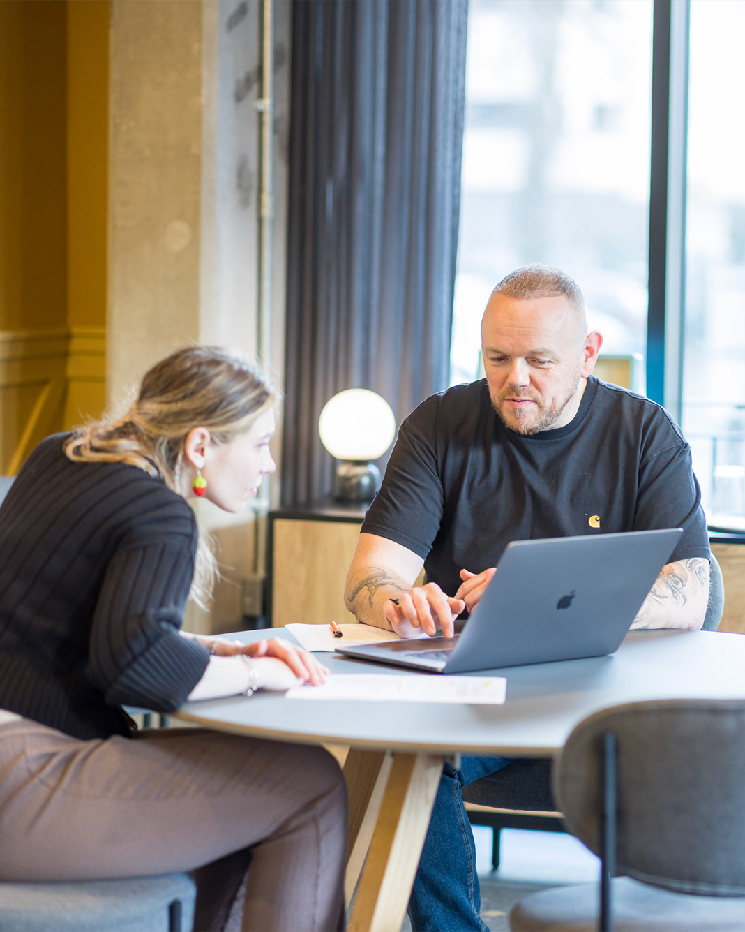 Darren mid-conversation in a working environment — natural light, documentary, no stock-photo smile.